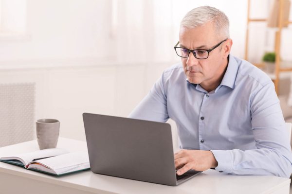 serious-senior-man-using-laptop-at-home-office-SFG2XGU_Easy-Resize.com_